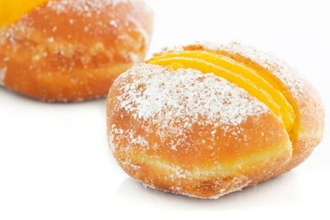 Two Berliner with egg creme over white Stock Photos