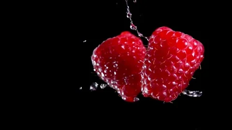 Two berries of raspberry are hitting each other Stock Footage 105877764