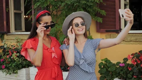 Two best cute sisters in a sunglasses and hat have fun, laugh, take selfies. Video stock 138076853
