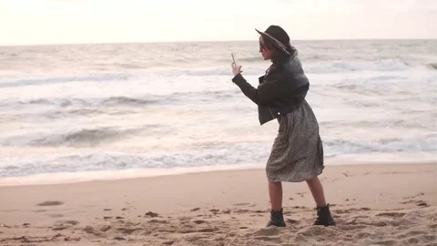 Two best friends on the beach making photo on smartphone and posing on camera Stock Footage 164865107