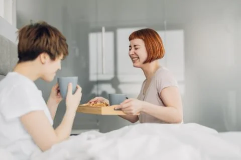 Two best friends having fun while drinking tea Stock Photos