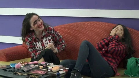 Two best friends laugh loudly and roll with laughter. Beautiful Oriental Video stock 89352053