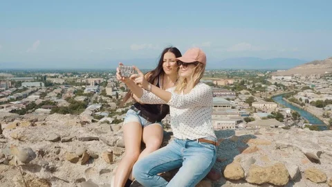 Two best friends went on a long trip abroad, ladies take selfies in front of Stock Footage 105968842