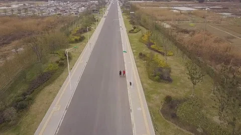 Two bicycles are riding on a road in China 스톡 동영상 86818385