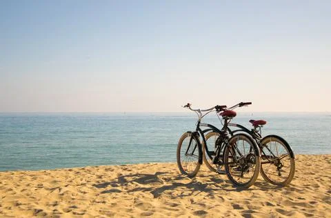 Two bicycles on the beach Stock Photos