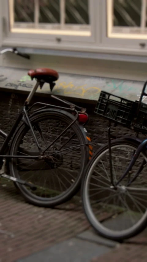 Two bicycles stand on a bustling sidewalk, evoking urban adventures Stock Footage 319651911