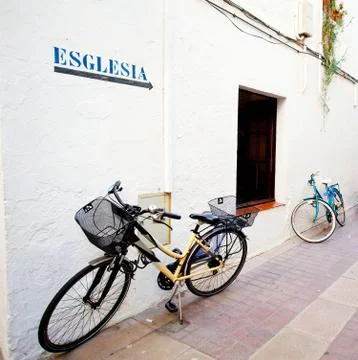 Two bicycles at a white wall Stock Photos