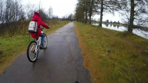 Two bicyclists ride on the sidewalk avoiding pedestrians Stock Footage 128149324