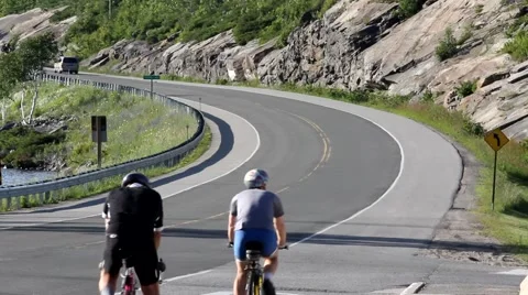 Two Bicyclists on a winding road Stock Footage 51722689
