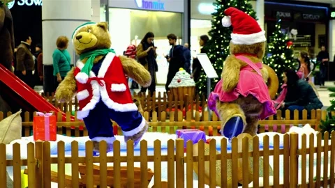 Two big artificial bear dolls dressed in Santa costumes are skating. Stock Footage 131423757