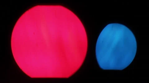 Two big bokeh lights together - red and blue on black background Stock Footage 46372786