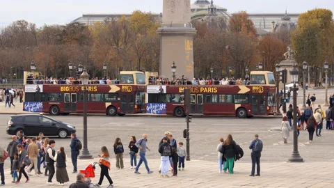 Two Big Bus buses full of tourists on the Place de la Concorde square in Paris Stock Footage 230141192