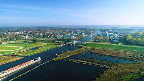 Two Big Cargo Boats Approaching a Bridge - Friesland, Holland 4K Drone Stock Footage 126837866