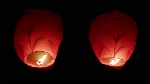 Two big fire paper lanterns floating in the night sky. Seamlessly looped. Stock-Footage 196515110