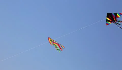 Two big kites fly high in the blue sky in the summer Stock-Fotos