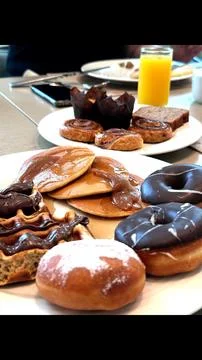 Two big plates filled with dessert waffles drizzled with chocolate, fluffy Stock Photos