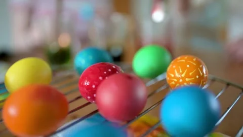 Two big sisters and their little brother dyeing Easter eggs at home. Stock Footage 304086500