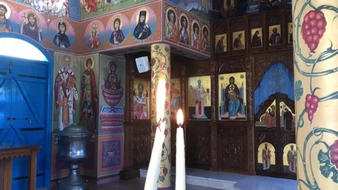 Two Big White Lit Candles Inside an Orthodox Chapel Stock Footage 90648151