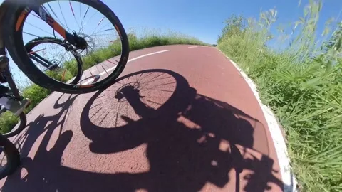 Two Bikers on bicycle lane a spring sunny morning backlight Stock Footage 133464784