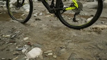 Two bikers biking on the river  slow motion Stock Footage 85668989