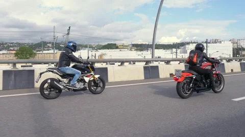 Two bikers in black rides on the road  Stock Footage 175809003