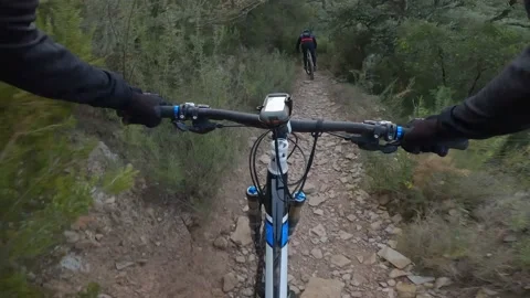 Two bikers descending a very technical mountain bike trail Video stock 174927467