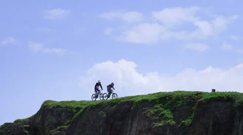 Two bikers racing on a mountain Stock Footage 47164061