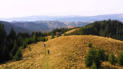 Two bikers riding down a mountain trail in autumn sunny day. Enduro Trails. Stock Footage 150664783