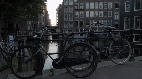 Two bikes on a bridge over Oudezijds Voorburgwal canal Stock Footage 58914260