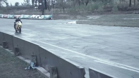 Two bikes coming into a corner on the test race Stock Footage 70327533