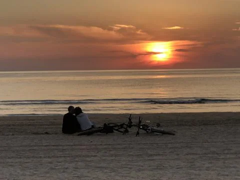 Two with bikes at sunset Stock Photos