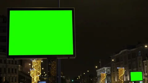 Two billboards, large and small with a green screen. On a festively decorated Video stock 85547499