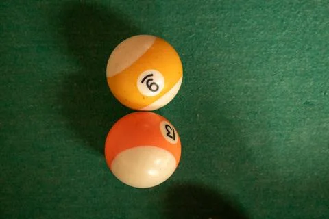 Two billiard balls number 9 and 13 on green pool table. Stock Photos
