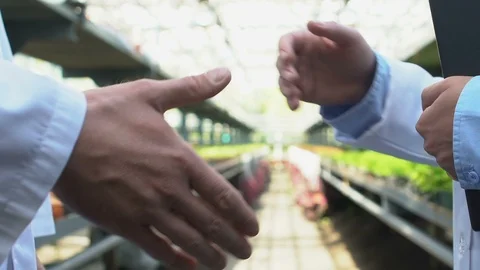 Two biology experts in uniform shaking hands, agricultural business agreement Stock-Footage 118910754