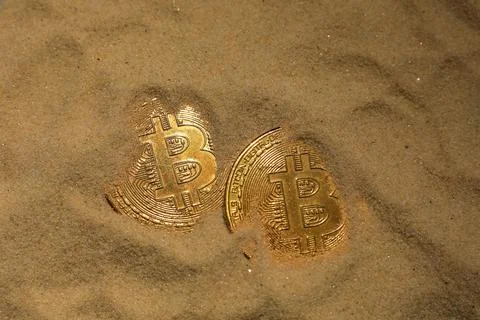 Two bitcoin coin on the sand Stock-Fotos