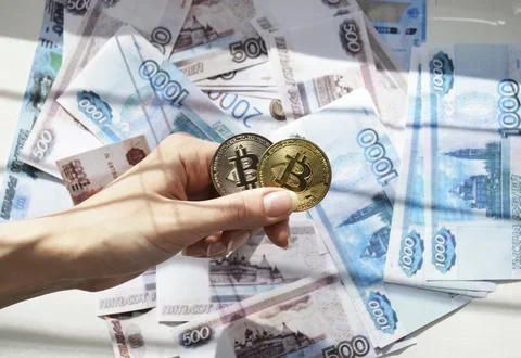 Two Bitcoin coins against a backdrop of Russian rubles Fotos de archivo
