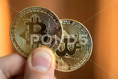 Two bitcoins in hand (Investment, course change, rise, decline, luxury, succe Stock Photos