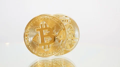 Two bitcoins spin on a white background Stock Footage 88336832