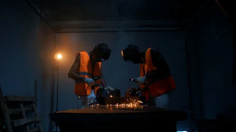 Two black African-Americans work with welding machines and weld metal structures Video stock 128748265