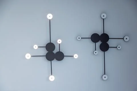Two black and white light fixtures with white bulbs Stock Photos