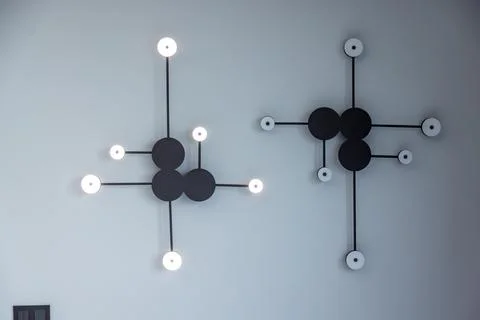 Two black and white light fixtures with white bulbs Stock Photos