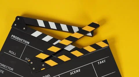 Two Black and yellow Clapper board or movie slate on yellow background. Stock Photos