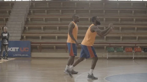 TWO BLACK BASKETBALL PLAYERS PRACTICING SHOTS INDOORS SLOW MOTION Stock Footage 99921891