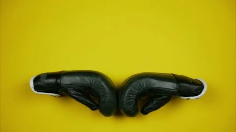 Two black boxing gloves moving towards each other. Stop motion animation Stock Footage 150085452