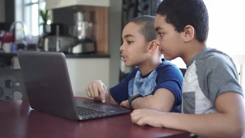 Two Black boy sitting playing on a laptop computer at home Stock-Footage 143046686