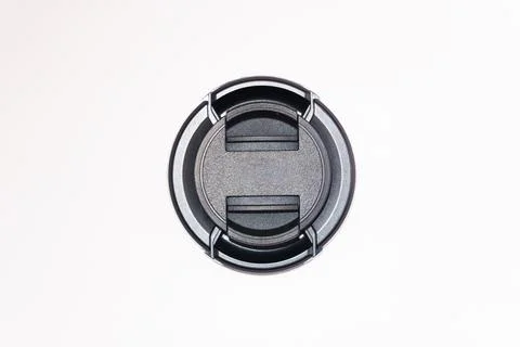 Two black camera lens caps of different sizes, a small and a large lens cap on a Stock Photos