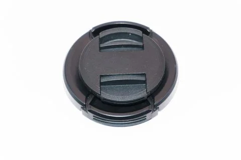 Two black camera lens caps of different sizes, a small and a large lens cap on a Stock Photos