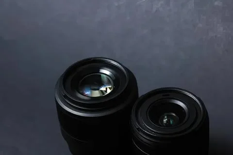 Two black camera lenses on dark background for photography Stock Photos