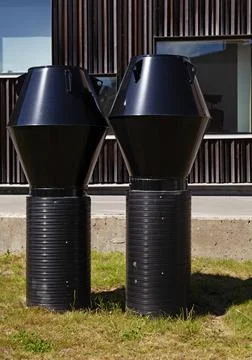 Two black chimneys for ventilation mounted on ground Stock Photos
