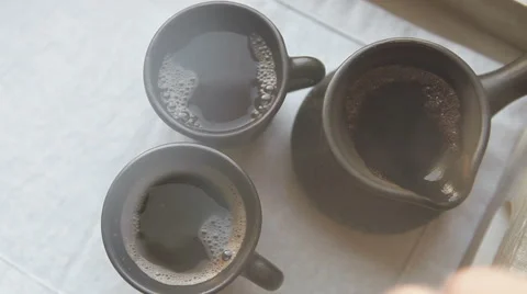 Two black coffee cups and clay ibrik on the wooden salver Stock Footage 58894559